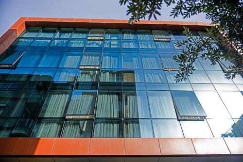 a tall glass building with many windows at My Sun Hotel in Izmir