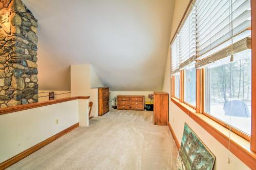 a room with a large window and a stone wall at Shelburne Studio Cabin with Spring-Fed Pool! in Shelburne