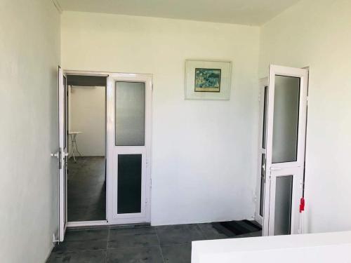 an empty room with two doors and a mirror at BREEZE DU NORD in Grand Baie
