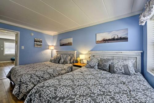 two beds in a bedroom with blue walls at North Wildwood Condo with Pool, Walk to Boardwalk! in North Wildwood