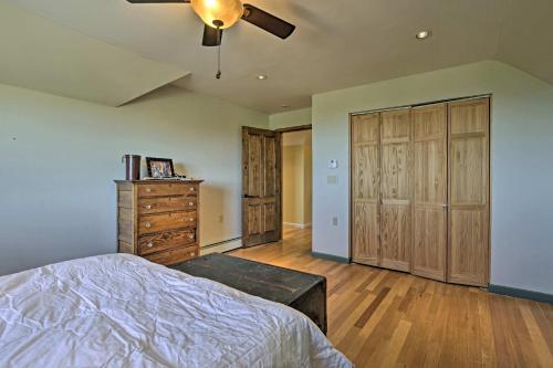 a bedroom with a bed and a dresser and a ceiling fan at Charming Mountain Estate with Views and Fire Pit! in Cerrillos
