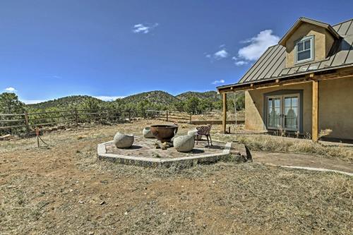 a house with a fire pit in the yard at Charming Mountain Estate with Views and Fire Pit! in Cerrillos