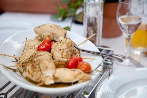 a plate of food with chicken and tomatoes on a table at Land-Gast-Hof WALKMÜHLE in Feuchtwangen
