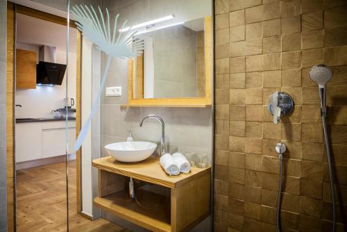 a bathroom with a sink and a shower at Apartmány pod Slavkáčom - Vysoké Tatry in Veľký Slavkov