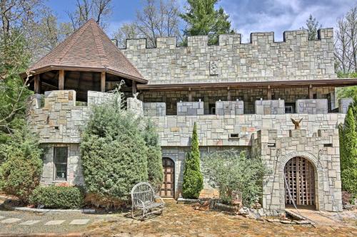 a large stone house with a stone wall at 11 Mi to Dtwn Murphy Gem with Hot Tub and Mtn Views! in Murphy