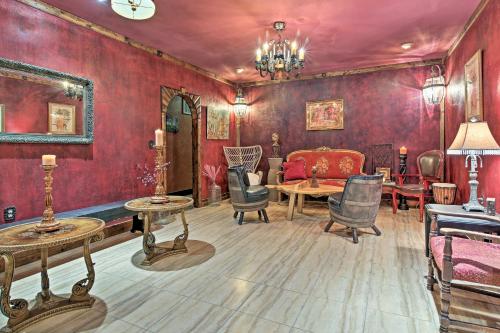 a living room with red walls and a table and chairs at 11 Mi to Dtwn Murphy Gem with Hot Tub and Mtn Views! in Murphy