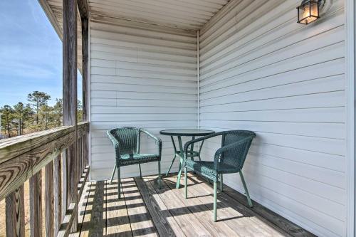 two chairs and a table on a porch at Chincoteague Townhome with Pony Views from Deck! in Chincoteague