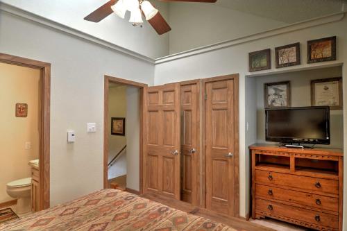 a bedroom with a bed and a flat screen tv at Red River Home with 2 Balconies - 1 Block to Main St in Red River