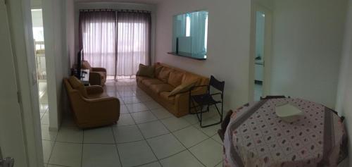 a living room with a couch and a table at Apto 3a Avenida Balneário Camboriu in Balneário Camboriú