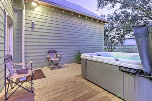 a hot tub on a deck with two chairs at Johnson City Home with Hot Tub - Close to Wineries! in Johnson City
