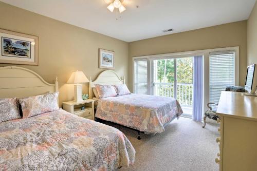 a bedroom with two beds and a window at Relax by Pool and Golf Chic Myrtle Beach Condo in Myrtle Beach