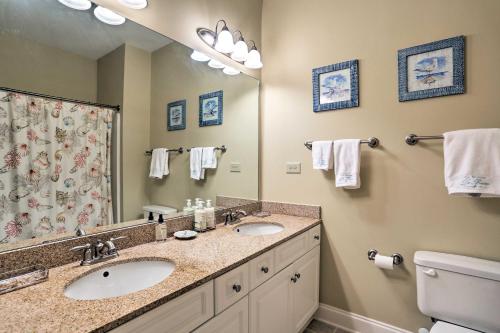 a bathroom with two sinks and a large mirror at Relax by Pool and Golf Chic Myrtle Beach Condo in Myrtle Beach