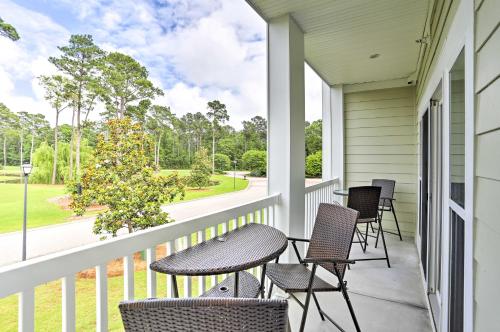 a porch with chairs and tables and a view of a yard at Relax by Pool and Golf Chic Myrtle Beach Condo in Myrtle Beach