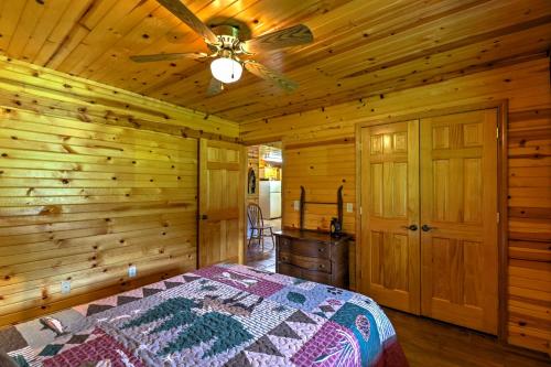 a bedroom with a bed and a ceiling fan at Dream Valley Mountain View Cabin with Covered Porch! in Mountain View