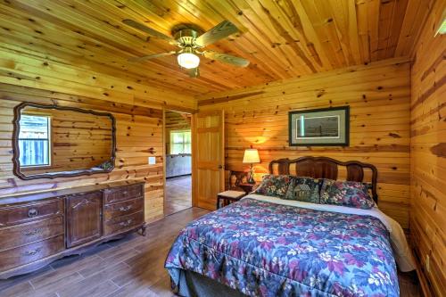 a bedroom with a bed in a log cabin at Dream Valley Mountain View Cabin with Covered Porch! in Mountain View