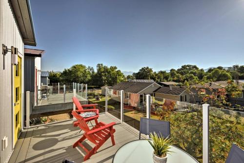 a balcony with two red chairs and a table at Missoula Getaway with Balcony, 2 Mi to Downtown! in Missoula