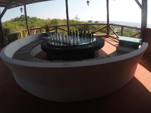 a round table with bottles on it on a balcony at The Heights in Montañita in Montañita