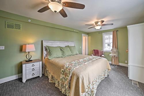 a bedroom with a bed and a ceiling fan at Downtown Branson Home with Pool Mins to The Landing! in Branson