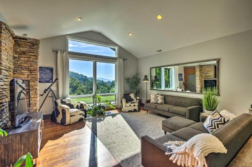 a living room with a large window and a couch at Luxury Lodge on 45 Acres Patio, Deck and Views! in Fairview