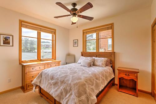 a bedroom with a bed and a ceiling fan at 7 Mi to National Park Grand Lake Condo with Deck! in Grand Lake