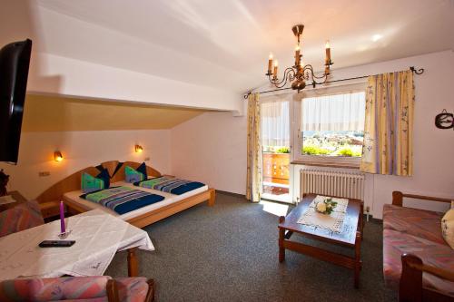 a hotel room with two beds and a window at Ferienwohnungen Appartements Patscheider in Finkenberg