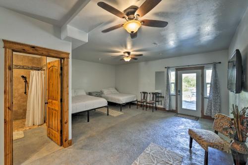 a room with two beds and a ceiling fan at Lava Hot Springs Studio - Walk to Portneuf River! in Lava Hot Springs