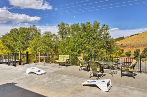 a patio with chairs and tables and a fence at Lava Hot Springs Studio - Walk to Portneuf River! in Lava Hot Springs