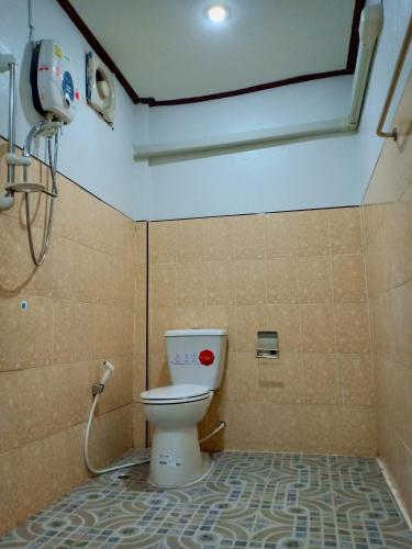 a bathroom with a toilet in a room at ณ สุข รีสอร์ท (Nasuk resort) in Khon Kaen