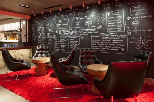 a restaurant with chairs and a chalkboard wall at Kimpton Hotel Vintage Portland, an IHG Hotel in Portland