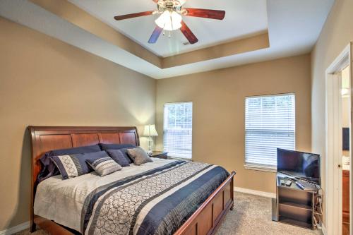 a bedroom with a bed and a ceiling fan at Branson Home with Deck Walk to The Strip and Creek! in Branson