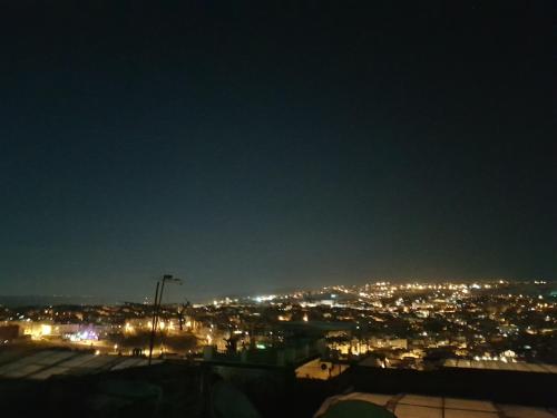 a view of a city lit up at night at Dar Atlantic in Fès