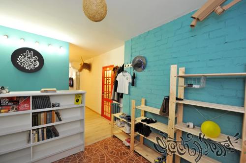 a room with a blue wall and shelves at Scotch Hostel in Volgograd