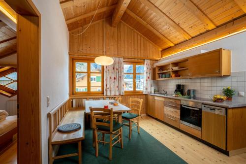 a kitchen with a table and chairs in a room at Ferienbauernhof Nigsch in Schoppernau