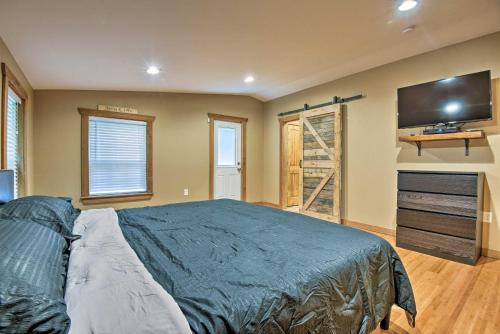 a bedroom with a bed and a flat screen tv at Spacious Kunkletown Home with Full Game Room and Deck! in Kunkletown
