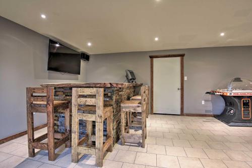 a bar with wooden stools in a room at Spacious Kunkletown Home with Full Game Room and Deck! in Kunkletown
