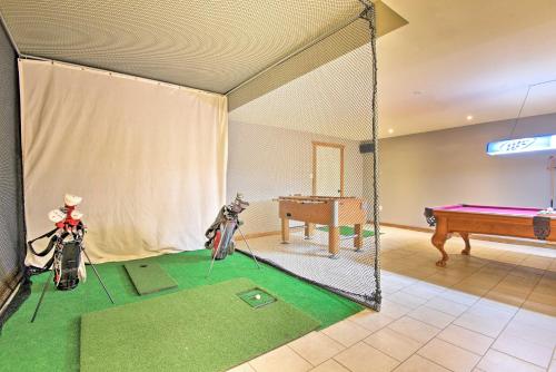 a batting cage with a ping pong table and a ping pong ball at Spacious Kunkletown Home with Full Game Room and Deck! in Kunkletown