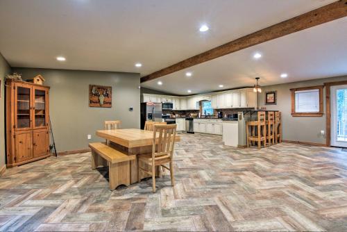 a large kitchen with a wooden table and chairs at Spacious Kunkletown Home with Full Game Room and Deck! in Kunkletown