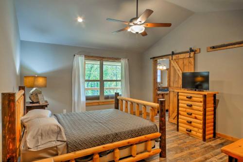 a bedroom with a bed and a ceiling fan at Summerville Getaway with Deck and On-Site Creek! in Summerville