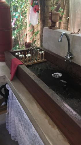 a kitchen sink with a red towel next to it at Pousada Spa Oasis in Caraíva