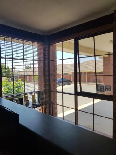 a room with large windows with a view of a street at Ararat Colonial Lodge Motel in Ararat