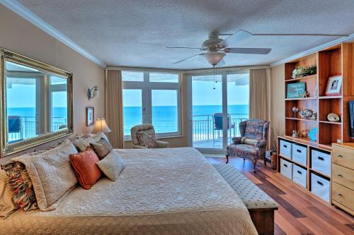 a bedroom with a bed with a view of the ocean at Waterfront Daytona Beach Shores Condo with Amenities in Daytona Beach Shores