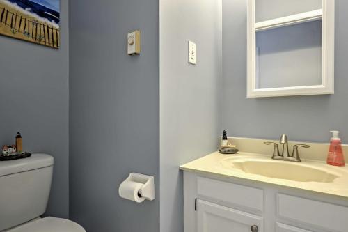 a bathroom with a sink and a toilet and a mirror at Central Sea Isle City Condo - 1 Block to the Beach in Sea Isle City