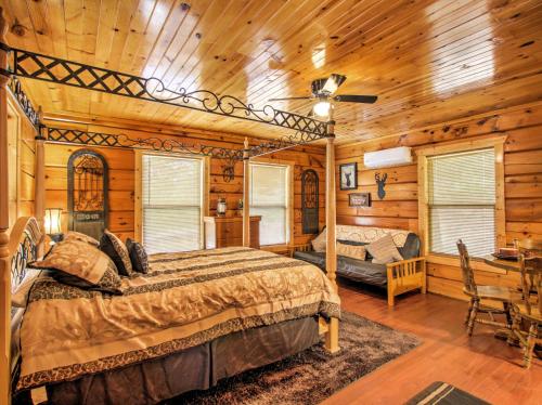 a bedroom with a bed and a desk in a room at Log Cabin Studio in Sevierville with Deck and Hot Tub! in Sevierville