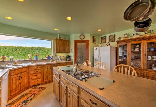 a large kitchen with wooden cabinets and a refrigerator at Charming Sequim House with Olympic Peninsula Views! in Sequim