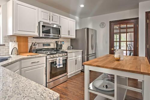 a kitchen with white cabinets and a wooden counter top at Family Home with Deck about 2 Mi to Camelback Mountain! in Tannersville