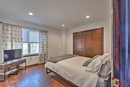 a bedroom with a large bed and a television at Family Home with Deck about 2 Mi to Camelback Mountain! in Tannersville