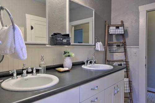 a bathroom with two sinks and a mirror at Fredericksburg Cottage with Grill - Walk to Main St! in Fredericksburg