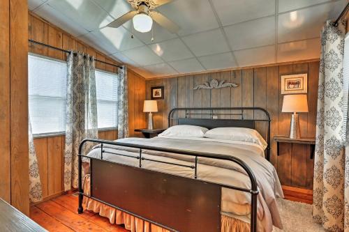 a bedroom with a bed in a room with wooden walls at Outer Banks Island Cottage - 1 Mi to Frisco Beach! in Frisco