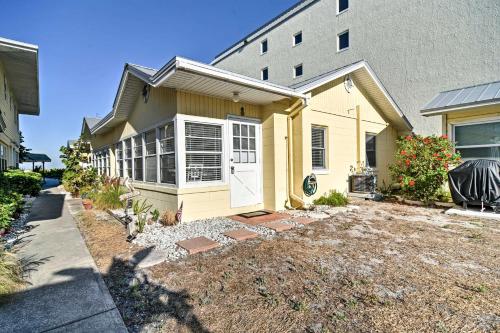 a house with a driveway in front of a building at Indian Shores Cottage with Cabana - Steps to Beach! in Clearwater Beach