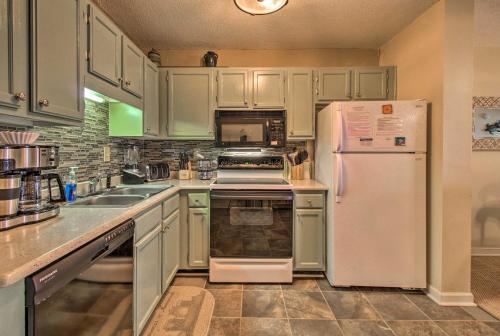 a kitchen with white cabinets and a white refrigerator at Oceanfront Hilton Head Island Condo with Pool Access in Hilton Head Island